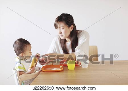 Mother and son eating breakfast View Large Photo Image Stock Image - Mother and son eating breakfast. Fotosearch