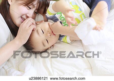 Mother and son laying down View Large Photo Image Stock Image - Mother and son laying down. Fotosearch