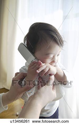 Mother Helping Baby Girl with Mobile Phone View Large Photo Image Stock Image - Mother Helping Baby Girl with Mobile Phone. Fotosearch
