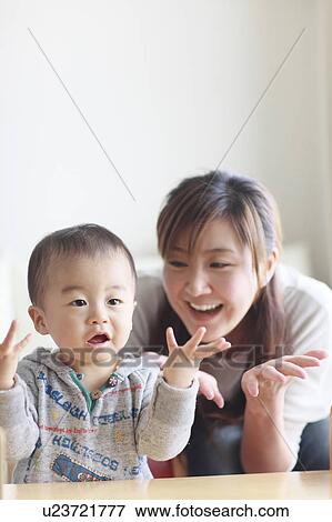 Mother Son Sitting Watching Television Arms Raised View Large Photo Image Stock Photo - Mother Son Sitting Watching Television Arms Raised. Fotosearch