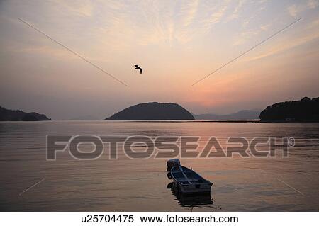 Stock Photography - Motorboat in Sea at Dawn. Fotosearch