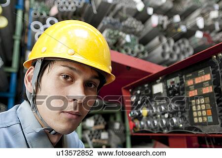 Stock Image - Portrait of Young Warehouse Worker. Fotosearch