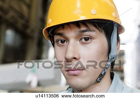 Stock Photograph - Portrait of Young Warehouse Worker. Fotosearch