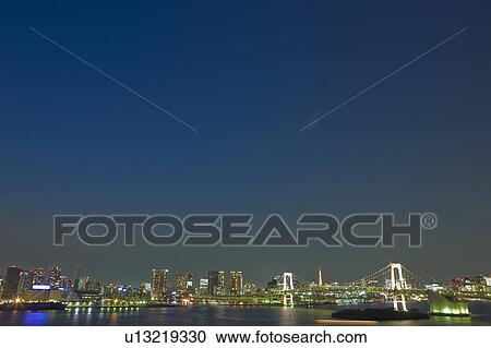 Stock Image - Rainbow Bridge and Tokyo at Night. Fotosearch