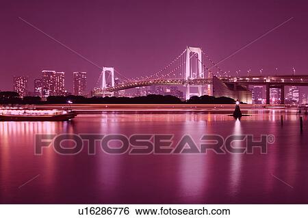 Stock Photograph - Rainbow Bridge Sea Nautical Vessel Illuminated . Fotosearch