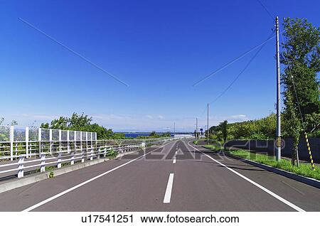 Stock Image - Road Curve Transportation Sea Tree. Fotosearch
