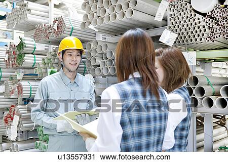 Warehouse Worker Talking to Two Female Colleagues View Large Photo Image Stock Image - Warehouse Worker Talking to Two Female Colleagues. Fotosearch
