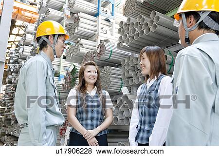 Stock Photo - Warehouse workers talking. Fotosearch