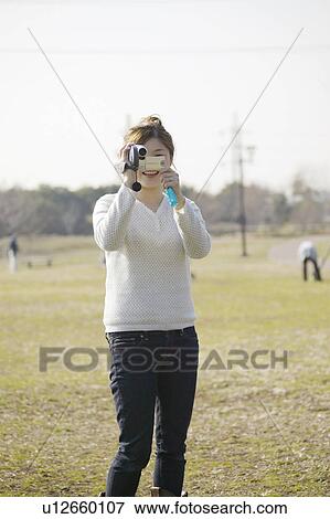 Stock Photo - Woman Filming. Fotosearch