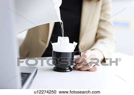Stock Image - Woman making coffee. Fotosearch