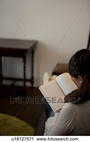 Stock Image - Woman reading a book. Fotosearch