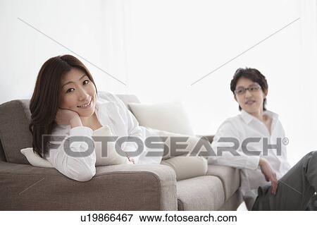 Stock Photo - Woman relaxing on sofa. Fotosearch