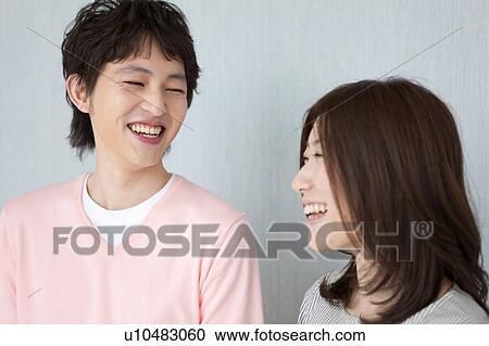 Young couple smiling View Large Photo Image Stock Image - Young couple smiling. Fotosearch