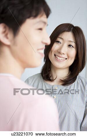 Stock Image - Young couple smiling. Fotosearch