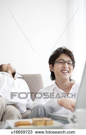 Young couple using laptop View Large Photo Image Stock Image - Young couple using laptop. Fotosearch