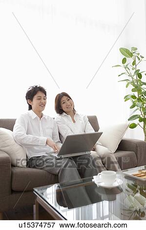 Young couple using laptop View Large Photo Image Stock Photo - Young couple using laptop. Fotosearch