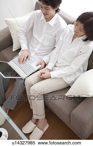 Young couple using laptop View Large Photo Image Stock Photography - Young couple using laptop. Fotosearch