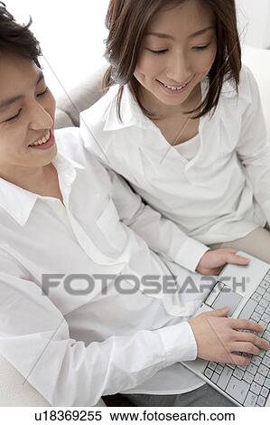 Young couple using laptop View Large Photo Image Stock Photography - Young couple using laptop. Fotosearch