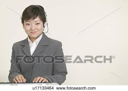 Young Female Customer Service Represententative Working View Large Photo Image Picture - Young Female Customer Service Represententative Working. Fotosearch