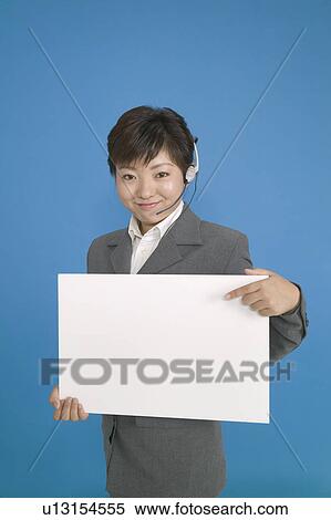 Young Female Customer Service Represententative Pointing at Blank Message View Large Photo Image Stock Photography - Young Female Customer Service Represententative Pointing at Blank Message. Fotosearch