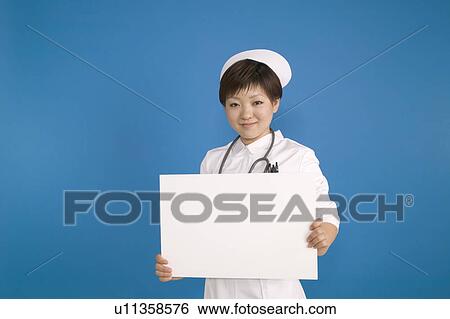 Stock Photograph - Young Female Nurse Holding Blank Message. Fotosearch