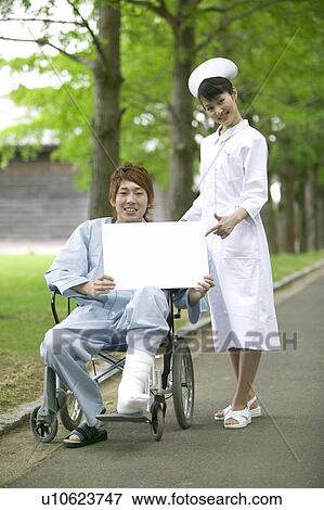 Stock Photo - Young Male Patient and Female Nurse Showing Blank Message. Fotosearch