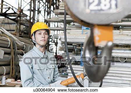Picture - Young Man Operating Pulley. Fotosearch
