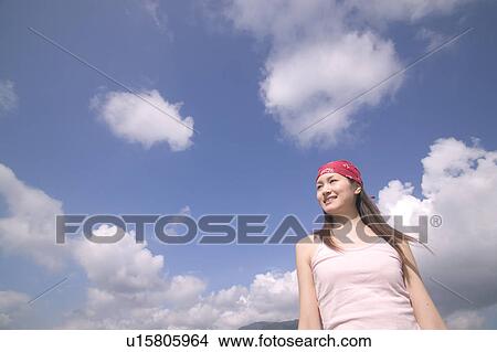 Young Woman Against Blue Sky View Large Photo Image Picture - Young Woman Against Blue Sky. Fotosearch