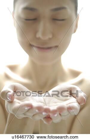 Stock Image - Young Woman Holding Hands Cupped. Fotosearch
