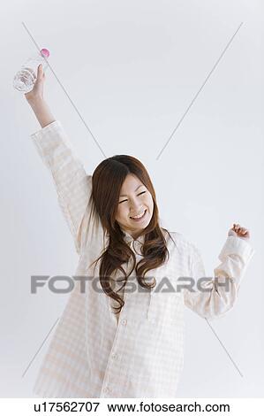 Stock Photo - Young woman in pajamas stretching. Fotosearch
