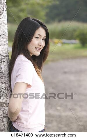 Young Woman Leaning on Tree View Large Photo Image Stock Image - Young Woman Leaning on Tree. Fotosearch