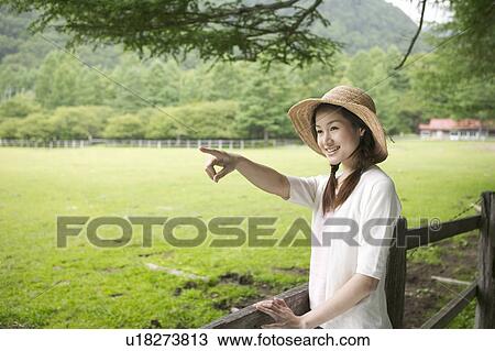 Young Woman Pointing by Field View Large Photo Image Stock Image - Young Woman Pointing by Field. Fotosearch