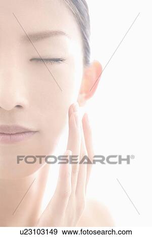 Stock Photo - Young Woman Touching Face. Fotosearch
