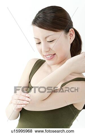 Young Woman Touching Her Elbow View Large Photo Image Stock Photo - Young Woman Touching Her Elbow. Fotosearch