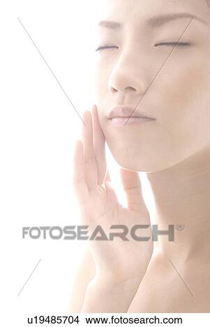 Young Woman Touching Her Face View Large Photo Image Picture - Young Woman Touching Her Face. Fotosearch
