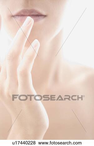Stock Photo - Young Woman Touching Her Lips. Fotosearch