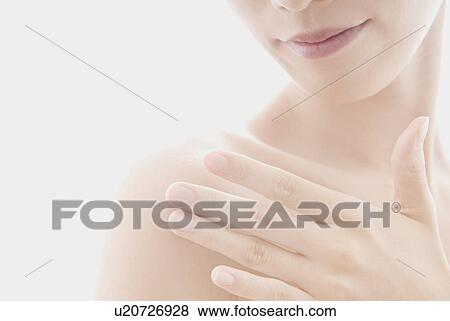 Stock Photo - Young Woman Touching Her Shoulder. Fotosearch