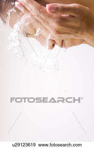 Stock Photo - Young Woman Washing Face. Fotosearch