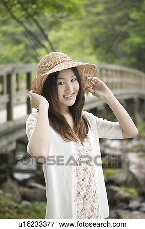 Stock Photo - Young Woman Wearing Hat. Fotosearch