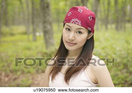 Stock Image - Young Woman with Bandanna in Forest. Fotosearch