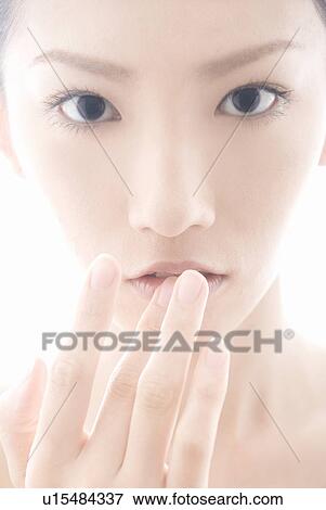 Stock Photo - Young Woman with Fingers on Lips. Fotosearch