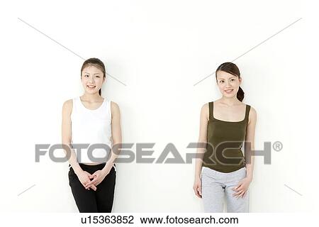 Stock Image - Young Women Against Wall. Fotosearch