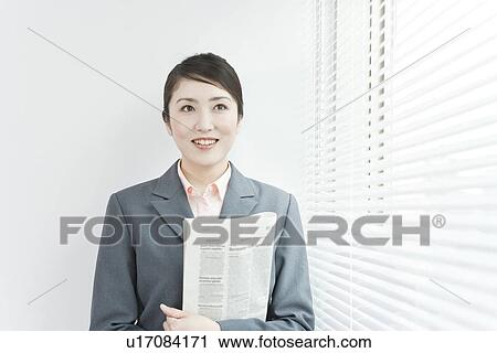 A business woman standing by windows View Large Photo Image Stock Image - A business woman standing by windows. Fotosearch