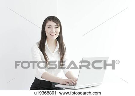 A business woman using computer View Large Photo Image Stock Image - A business woman using computer. Fotosearch