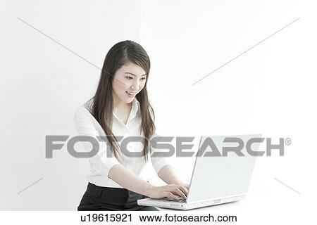 A business woman using computer View Large Photo Image Stock Image - A business woman using computer. Fotosearch