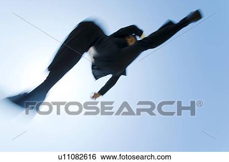 A businessman jumping View Large Photo Image Stock Photograph - A businessman jumping. Fotosearch
