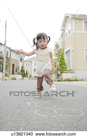 A girl playing on the street View Large Photo Image Stock Image - A girl playing on the street. Fotosearch