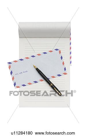 Stock Image - Air mail envelope, note pad and fountain pen. Fotosearch