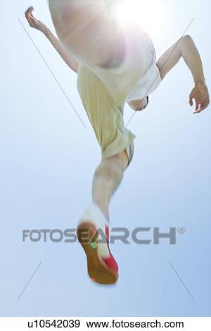 Stock Photo - An athlete jumping. Fotosearch