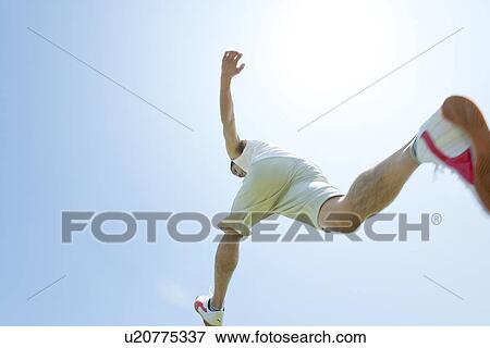 Stock Photo - An athlete jumping. Fotosearch